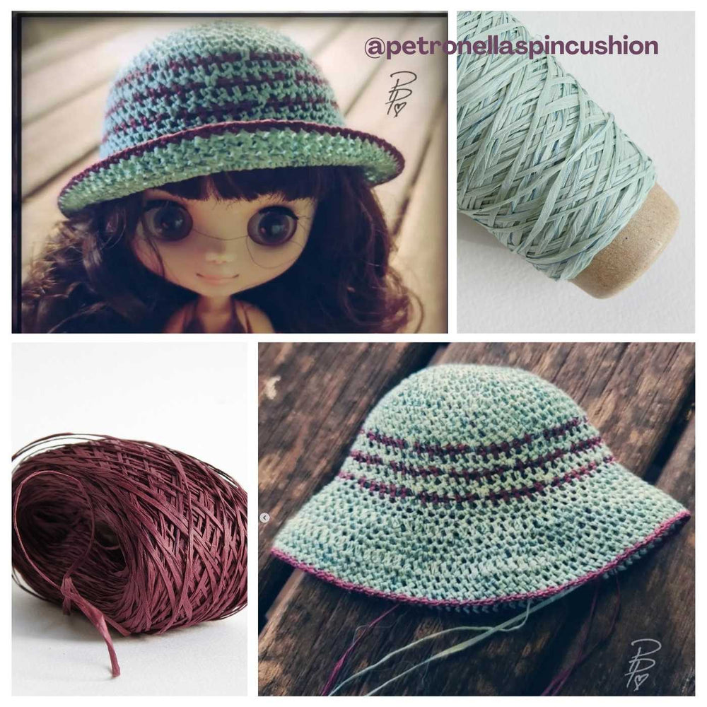 Tiny crocheted dolls hat using Habu Textiles Silk Wrapped Paper Yarn in Wine and Sky Blue