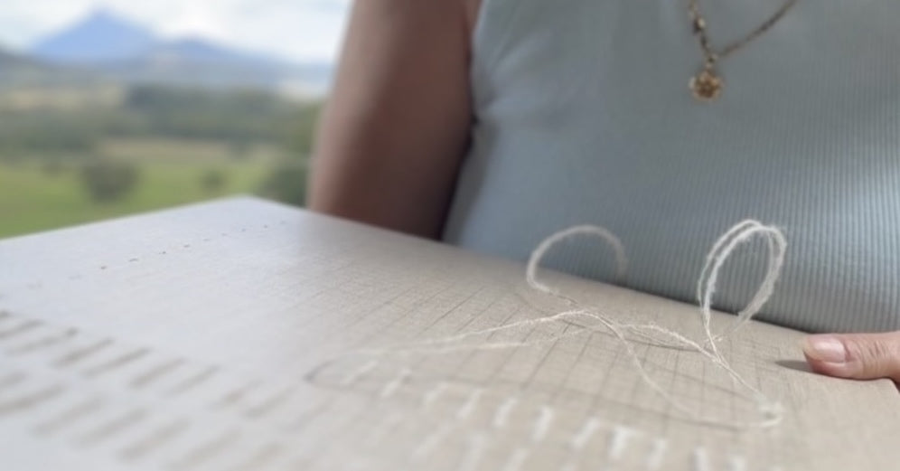 Helen Otway working on a stitched artwork, cropped.