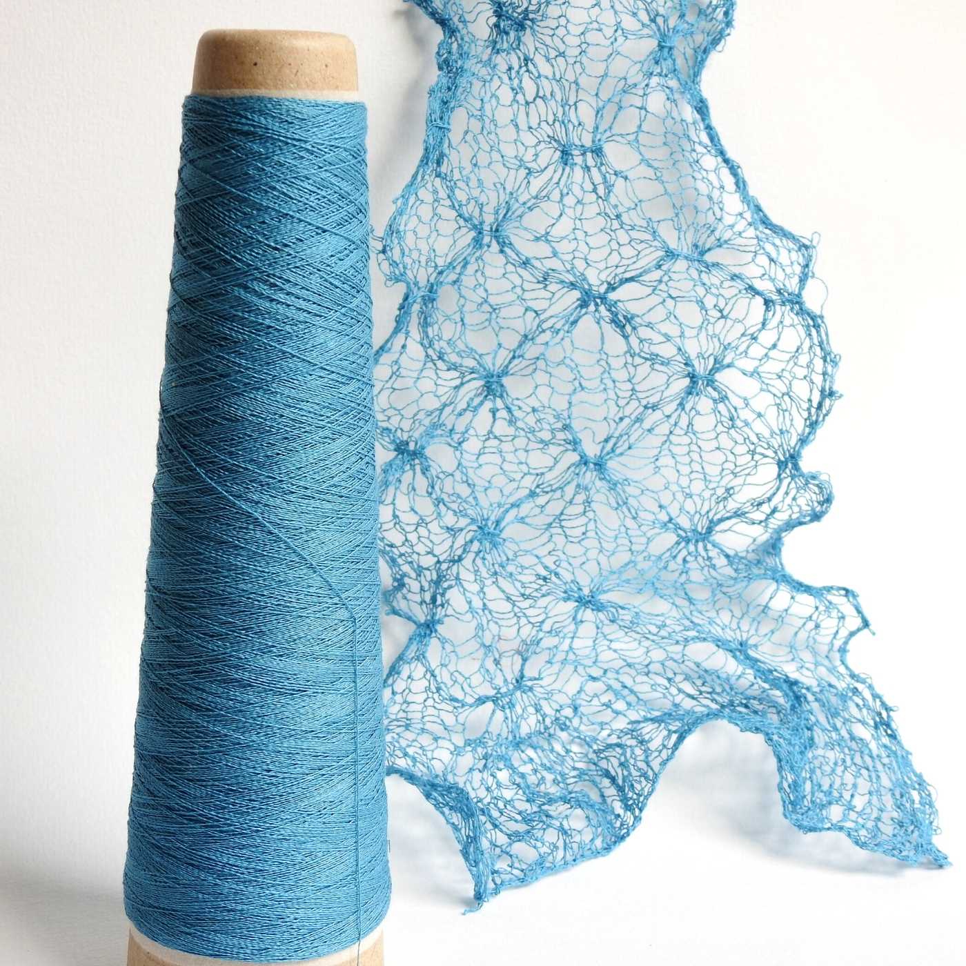 Knitted lace scarf (the Tin Roof pattern) using Habu Textiles Silk Stainless Steel yarn in Sky