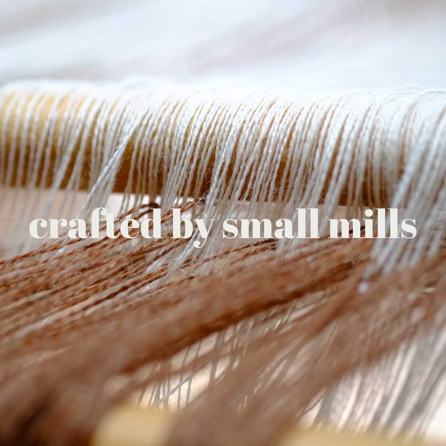 A small hand weaving loom respresenting artisan made yarns and fibres.