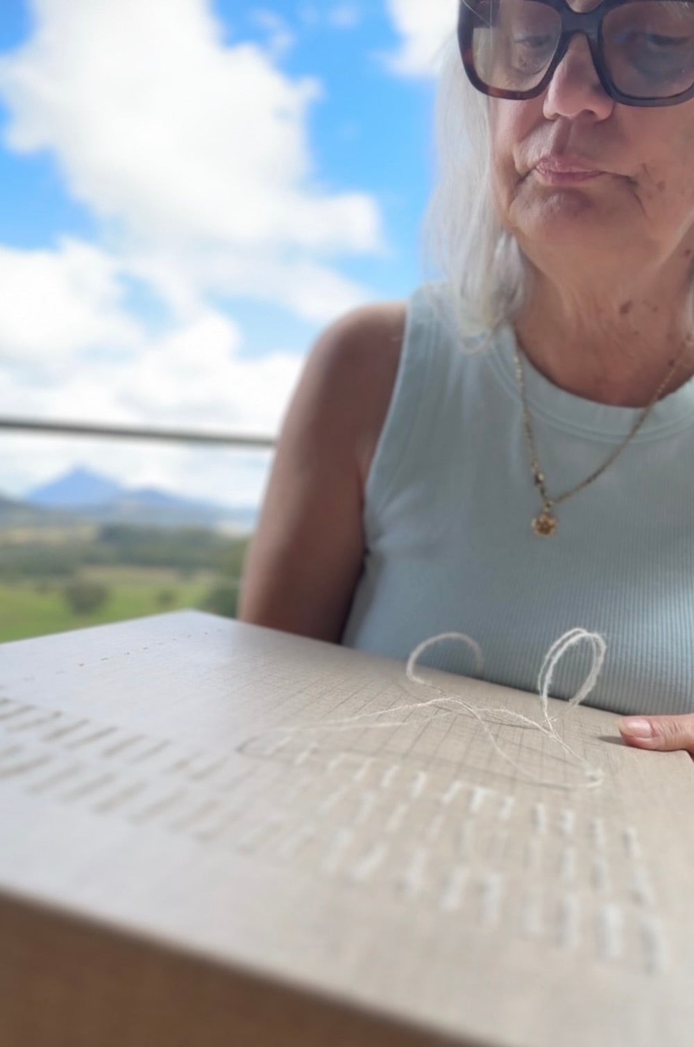 Helen Otway working on a stitched artwork.