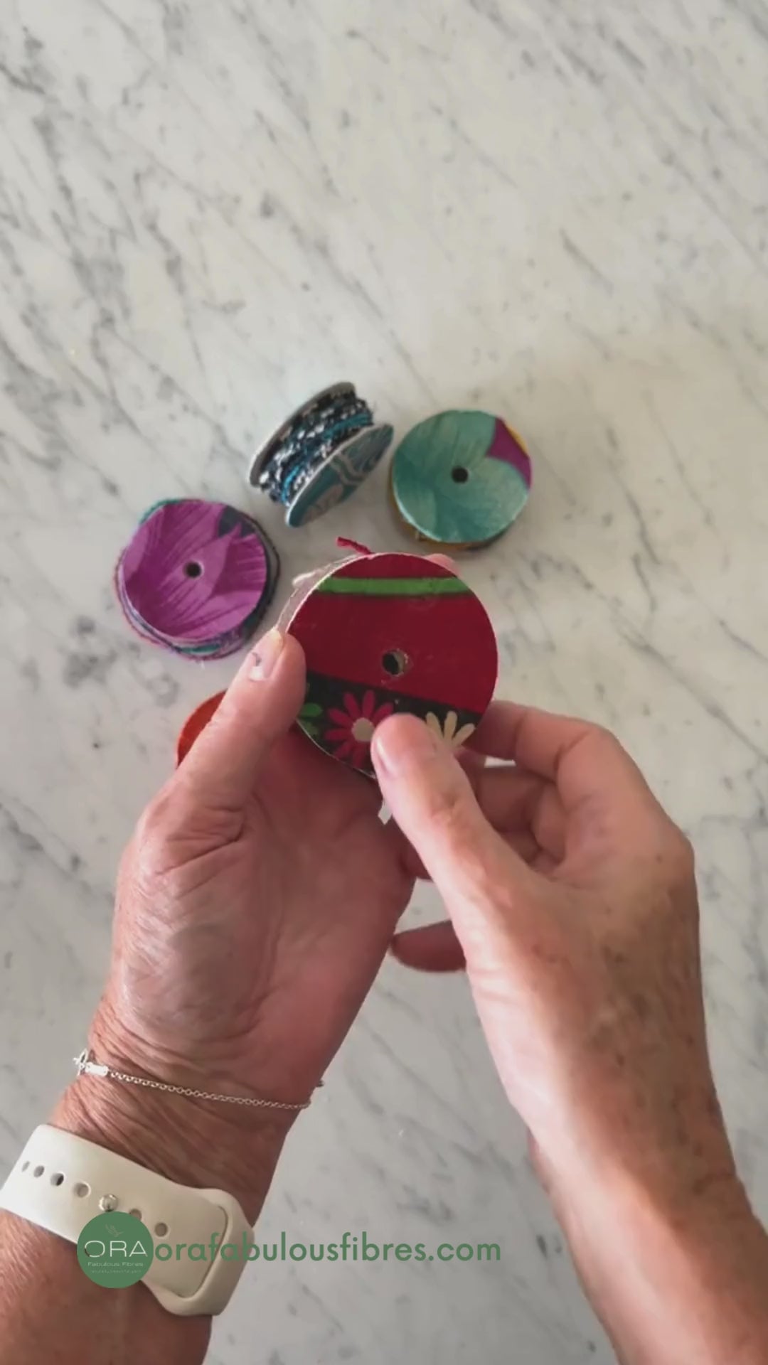 spool of upcycled cotton wire in green being twisted and pulled to show the flexibility and pliability of the craft wire.