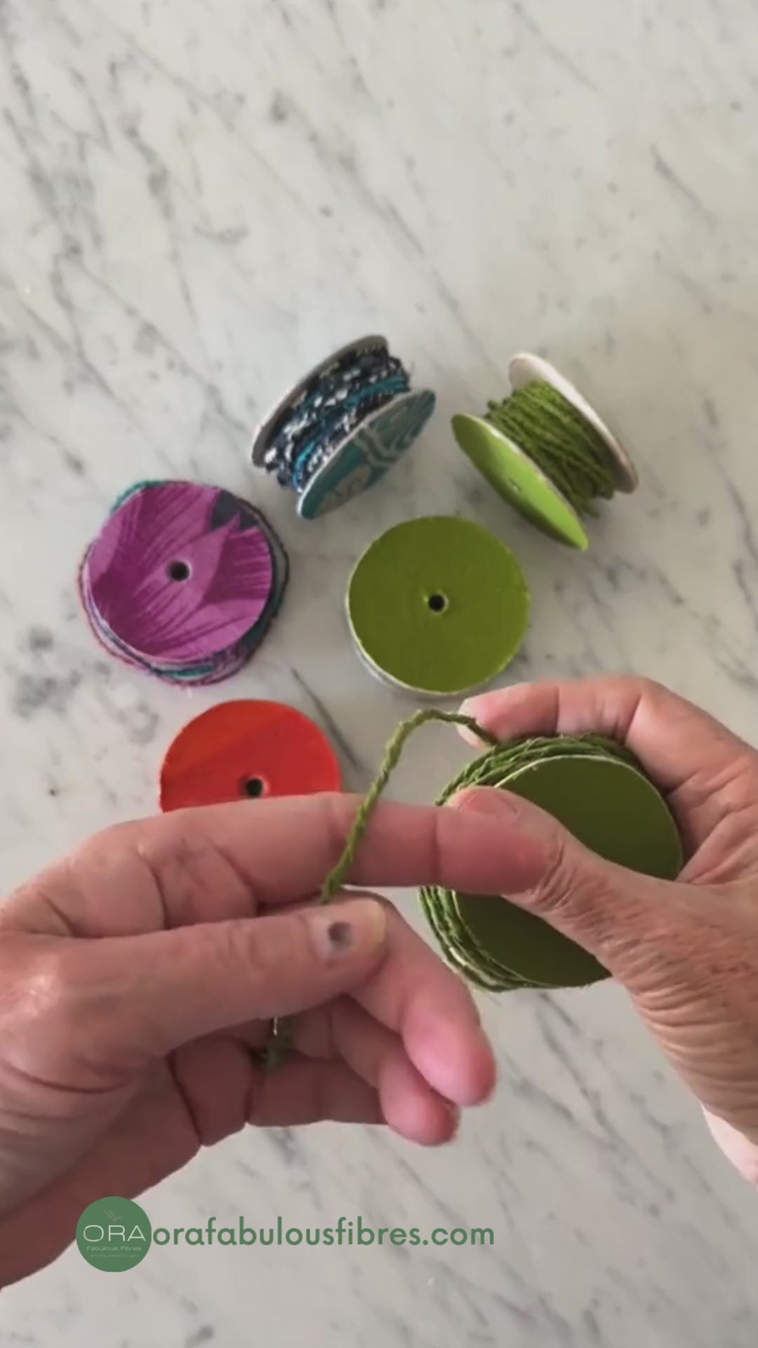 spool of upcycled cotton wire in green being twisted and pulled to show the flexibility and pliability of the craft wire.