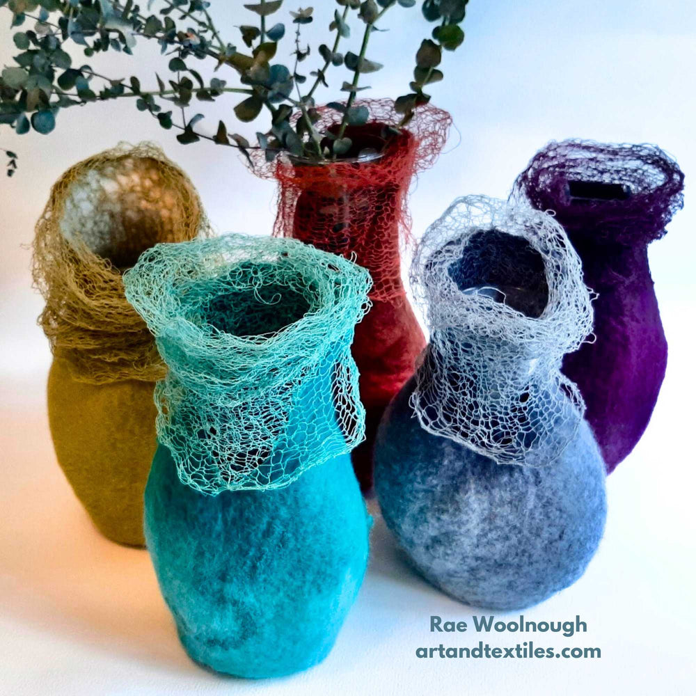 a group of hand crafted felt vessels made by textile artist Rae Woolnough. The vessels are organically shaped and felted and have a matching collar knitted from silk stainless steel yarn. Habu Textiles Silk & Stainless Steel yarn