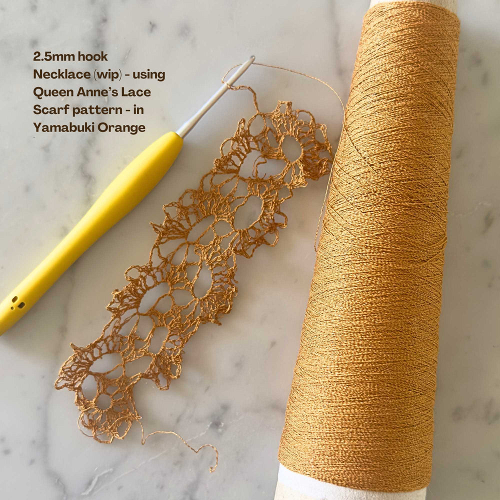 
                      
                        crochet work in progress using habu textiles silk stainless steel in yamabuki orange. pattern is the queen anne lace scarf - repurposing for a necklace
                      
                    