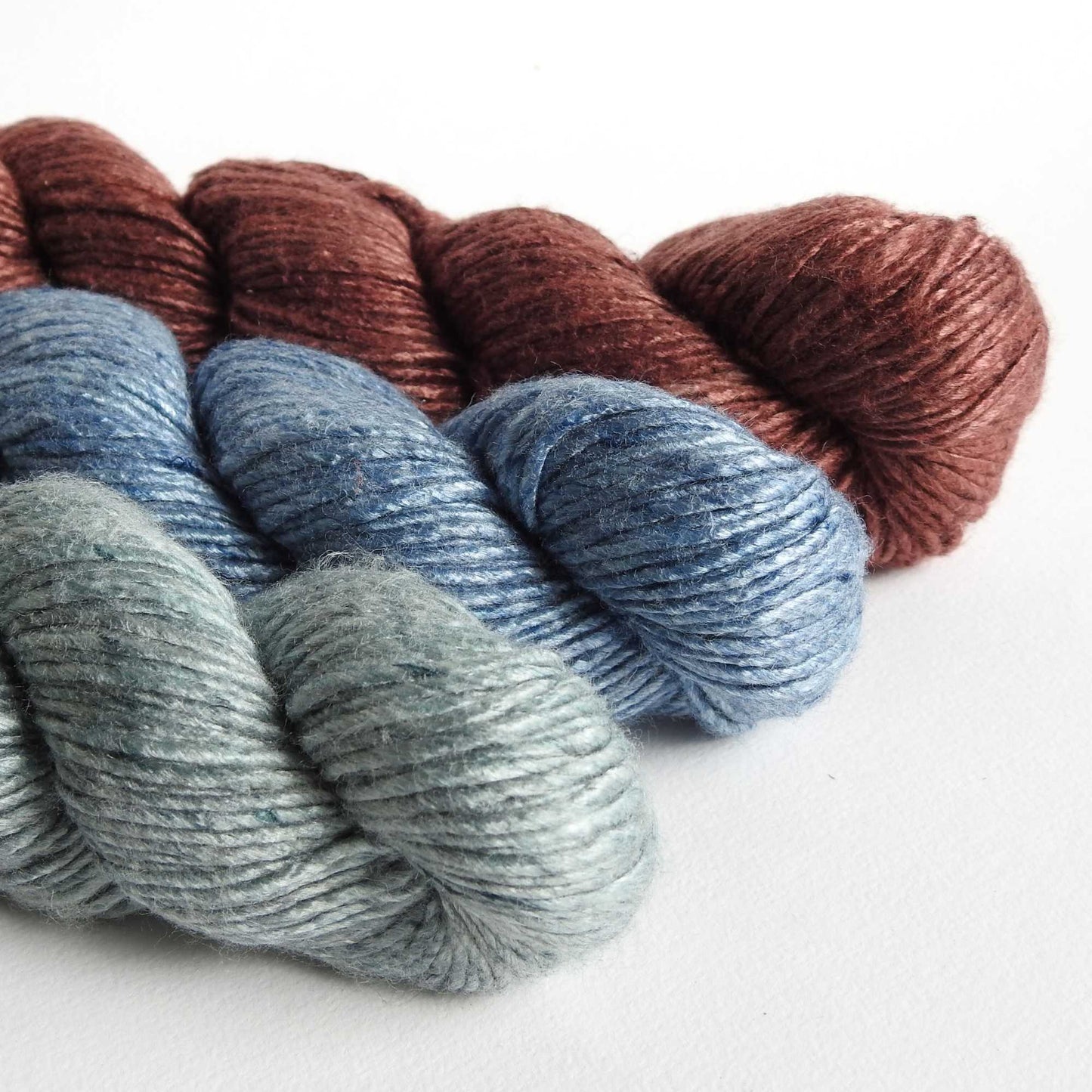 
                  
                    skeins of soft silky 100% bamboo yarn in seagreen, chocolate and steel blue. A natural chunky yarn which is silky and soft with a beautiful sheen. For garments, weaving, bags, mixed media art. 
                  
                