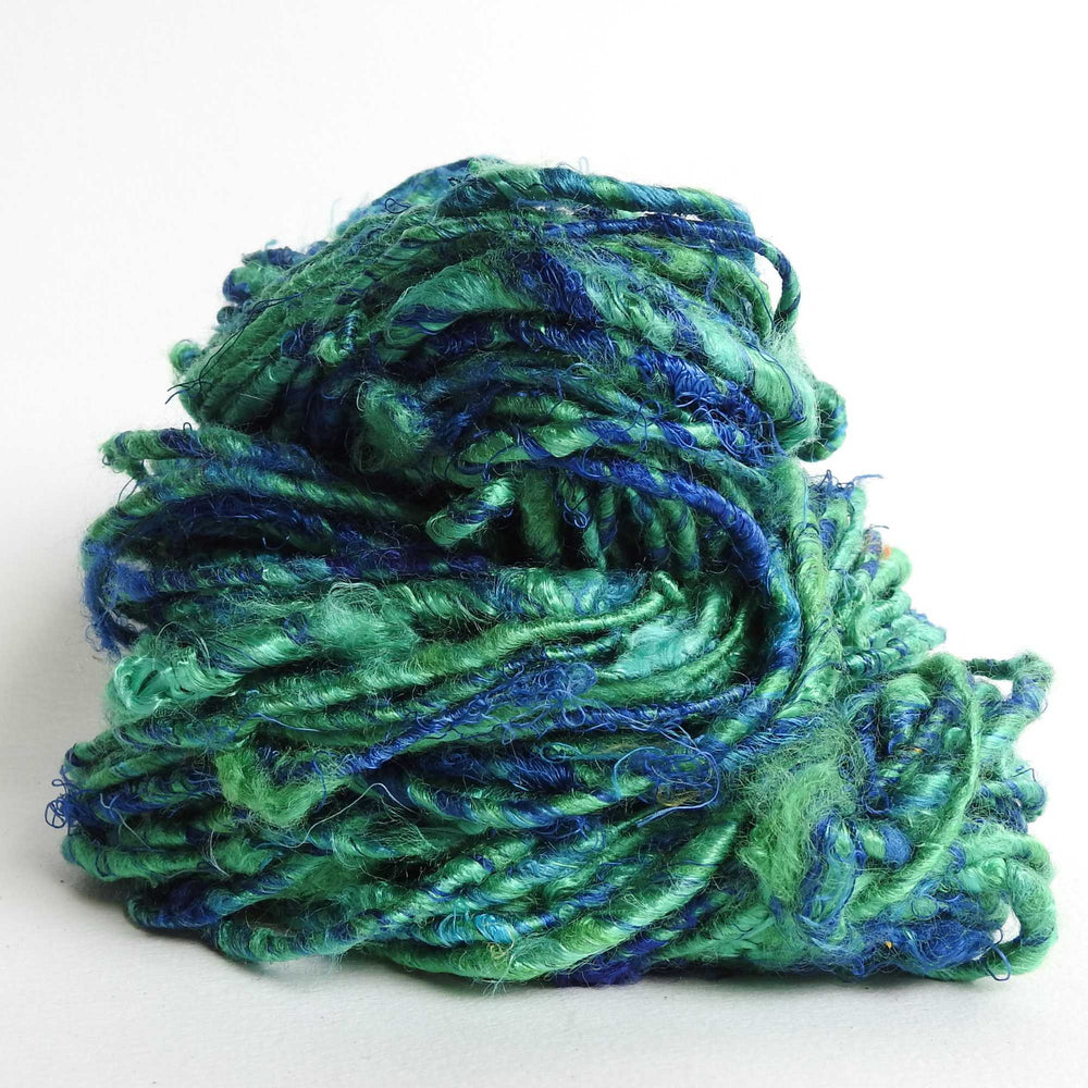 
                  
                    A ball of Banana Silk Yarn in Meditteranean. Natural, vegan banana fiber yarn for weaving, punch needle, knitting, crochet. Soft, squishy, chunky yarn.
                  
                