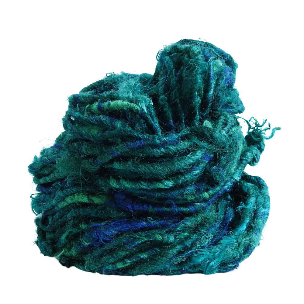 
                      
                        A ball of Banana Silk Yarn in Rain Forest. Natural, vegan banana fiber yarn for weaving, punch needle, knitting, crochet. Soft, squishy, chunky yarn.
                      
                    