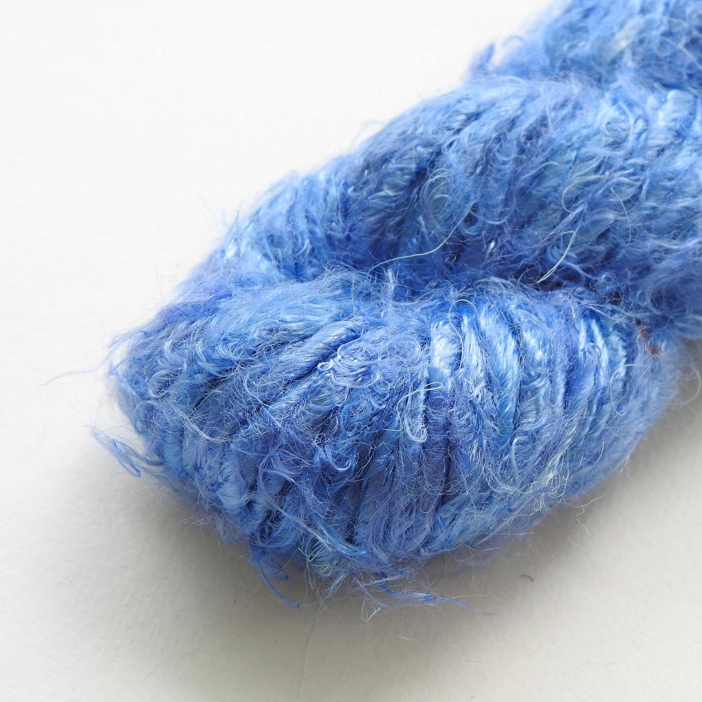 
                  
                    A ball of Banana Silk Yarn in Blue Bell. Natural, vegan banana fiber yarn for weaving, punch needle, knitting, crochet. Soft, squishy, chunky yarn.
                  
                