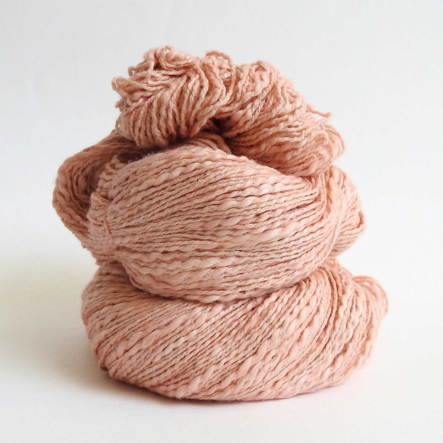 
                  
                    Skein of organic natural Cotton yarn in soft apricot. Cotton yarn is super soft with a slight slub for texture. Cotton knitting yarn Australia in off white. For knitting, weaving and crochet
                  
                