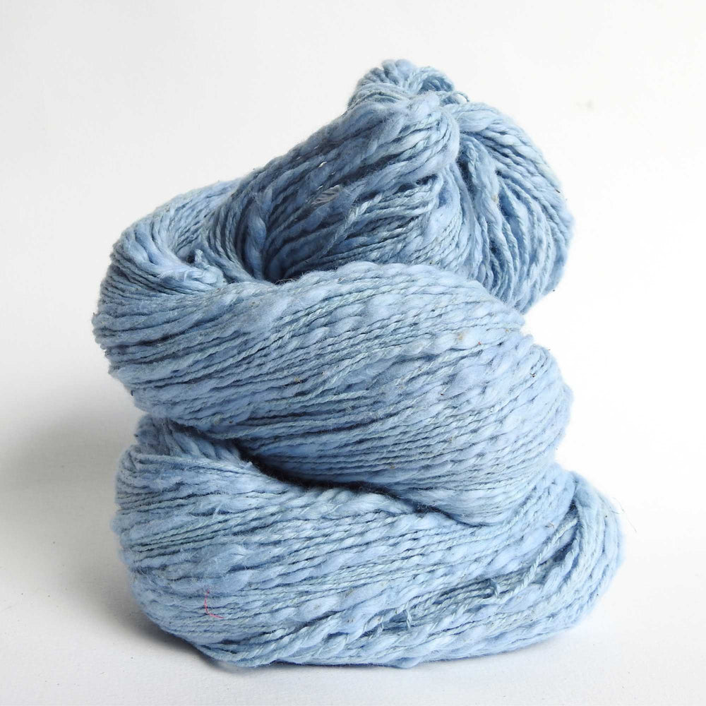 Skein of organic natural Cotton yarn in soft blue. Cotton yarn is super soft with a slight slub for texture. Cotton knitting yarn Australia in off white. For knitting, weaving and crochet