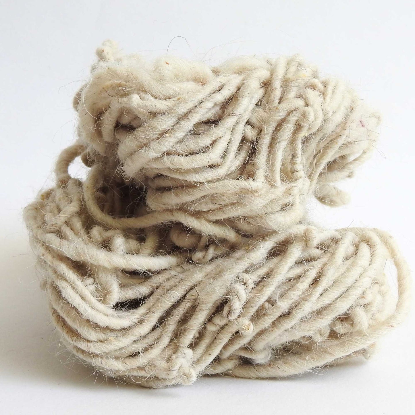 Felted wool yarn with over spin for texture. Lightly felted. Natural New Zealand wool. Use for weaving, macrame, baskets, hats. textile arts, dyeing.