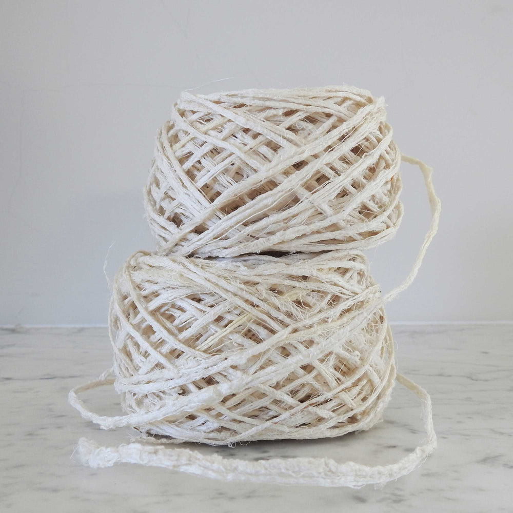 A ball of Habu Textiles Kibiso Silk yarn. 100% raw silk slow crafted chunky yarn for weaving, textile arts. Ball of natural silk yarn. Make beautiful bags, sculptural garments and textile art. Habu Textiles N-63