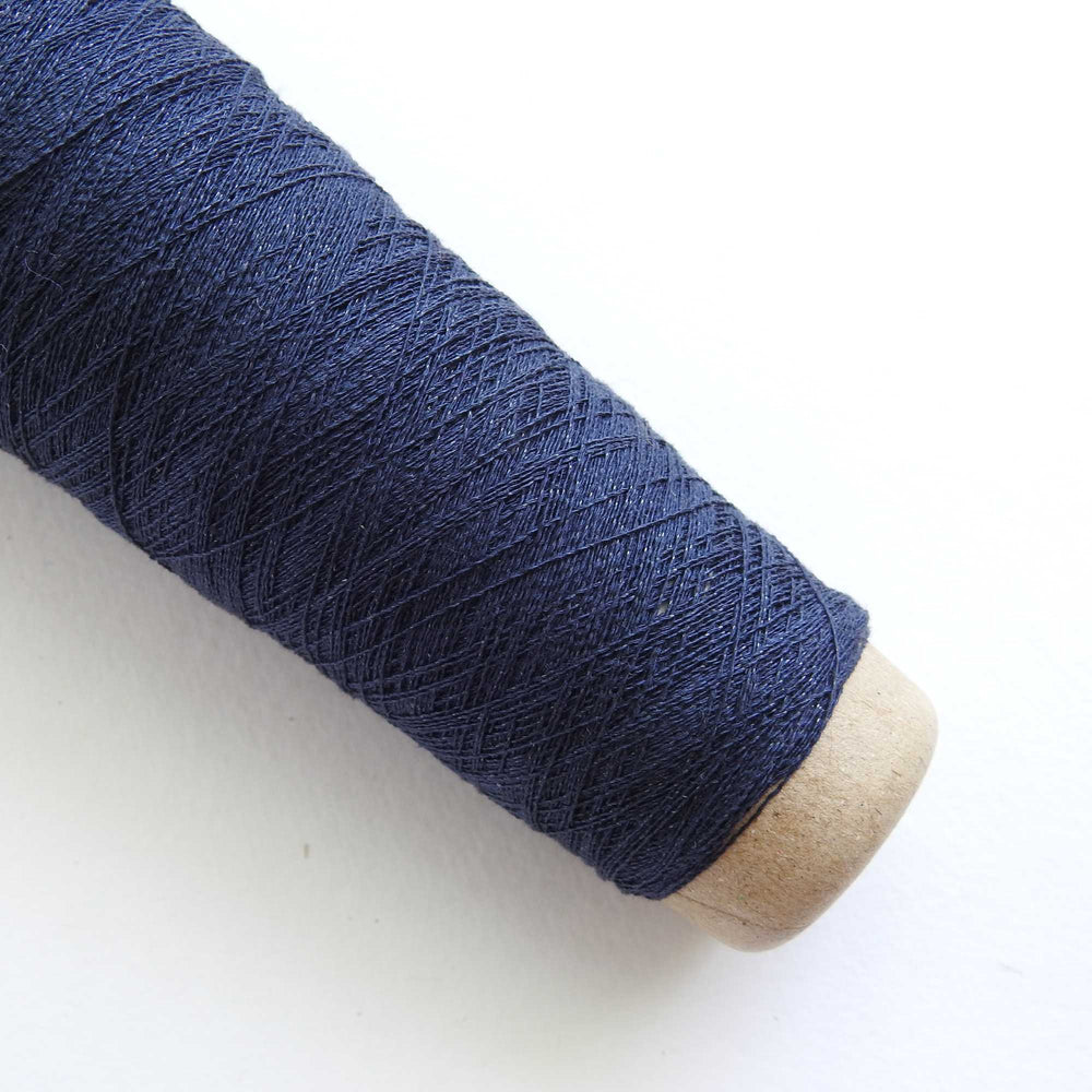 
                      
                        A cone of Silk Stainless Steel lace weight yarn in Navy for knitting crochet and weaving. Make beautiful scarves, garments and jewelry. The yarn has a stainless steel core with fine silk wrapped around it. They cone of yarn has a very elegant sheen and is beautiful to look at. Habu Textiles A20
                      
                    