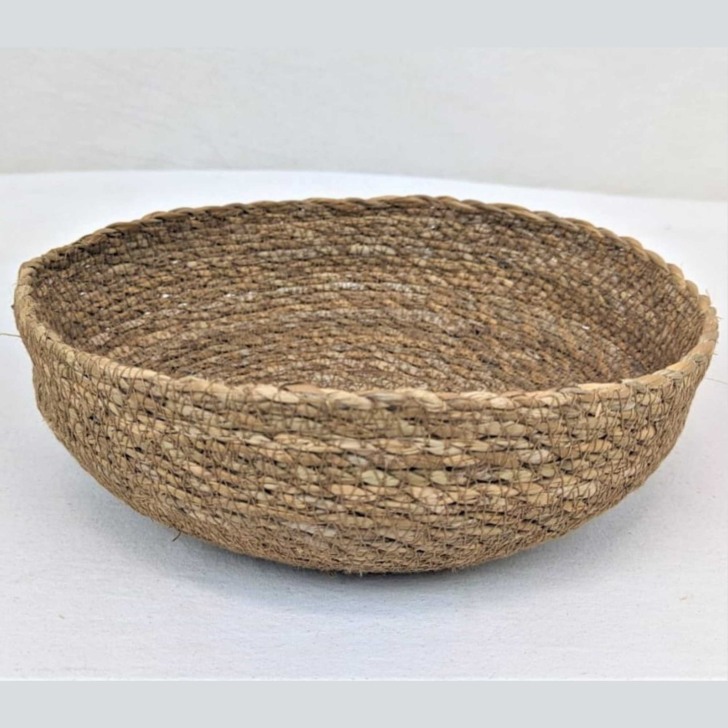 basket crafted using hogla cord, a natural grass harvested and hand produced in bangladesh. sustainably grown. very strong and durable cord