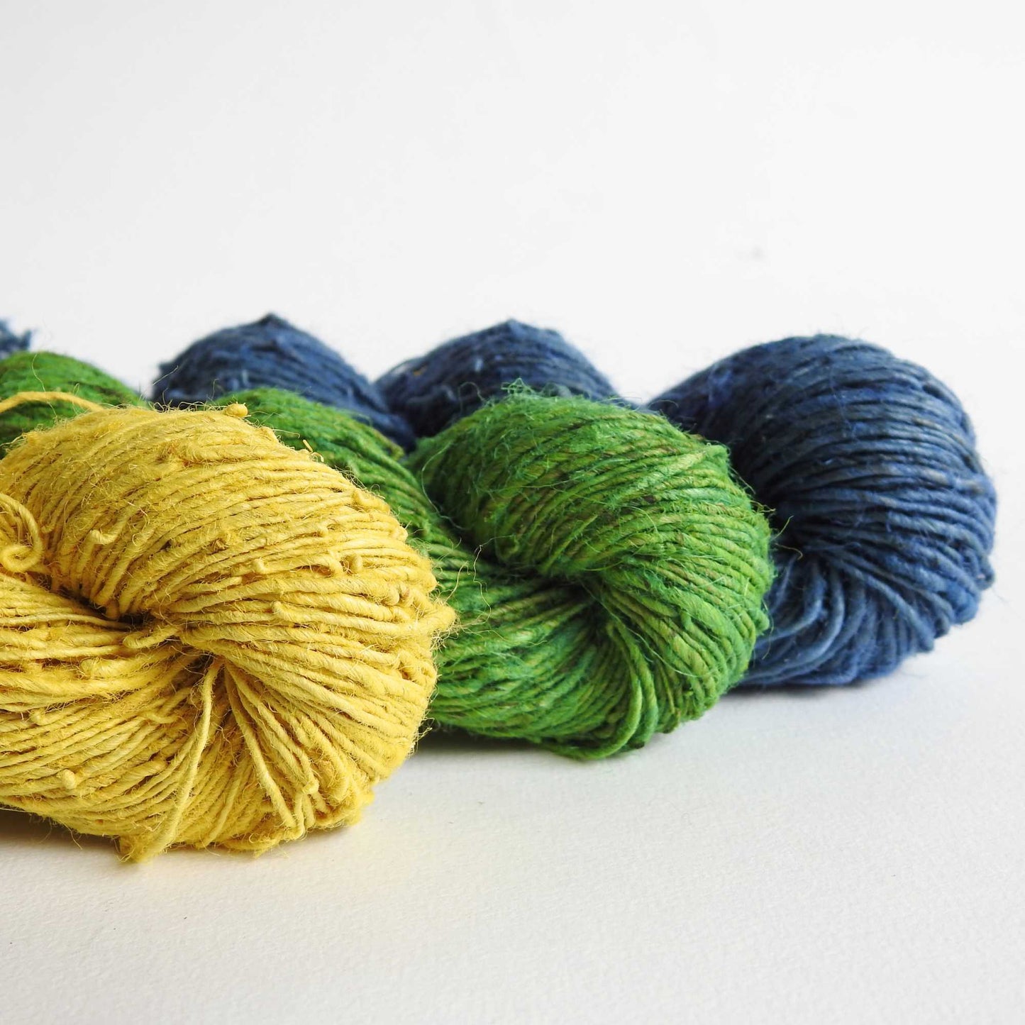 
                  
                    A trio of skeins of Nettle yarn in Dandelion, Spruce & Denim. Nettle is a highly sustainable and eco friendly crop. ORA Fabulous Fibres Nettle yarn is hand spun with a beautiful thick and thin texture giving it a rustic finish. Nettle yarn is available in a range of colours.
                  
                