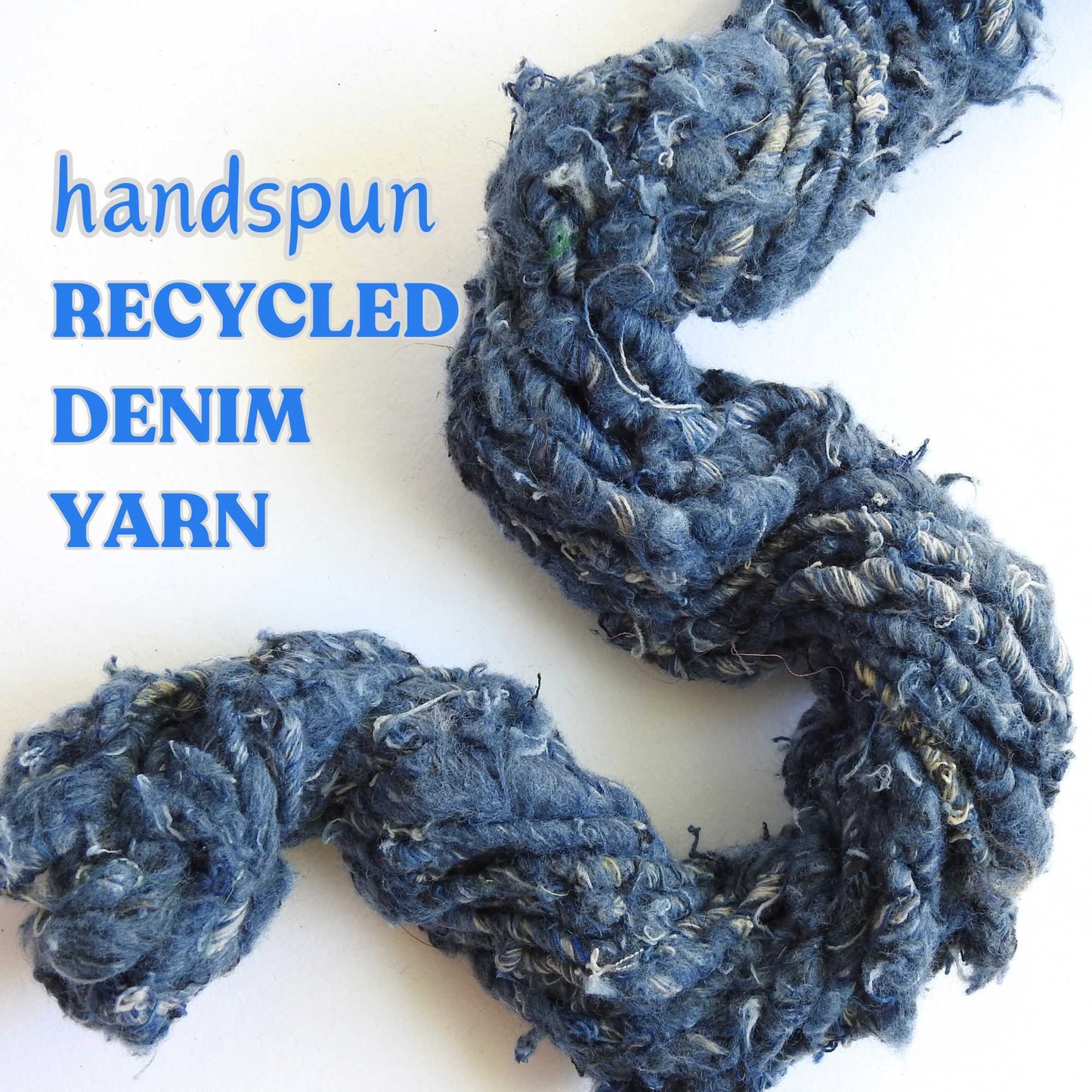 a hank of recycled denim yarn. our recycled denim is handspun with loads of texture. hand crafted from repurposed denim jeans. soft and chunky yarn for weaving, knitting, crochet