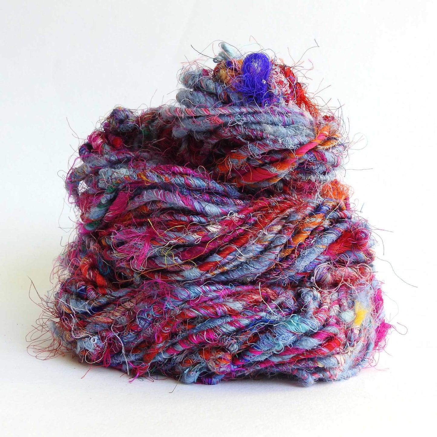 Ball of Recycled wool and silk yarn in purple heather. Soft, thick yarn for weaving, knitting, crochet and macrame. Hand spun, chunky natural yarn.