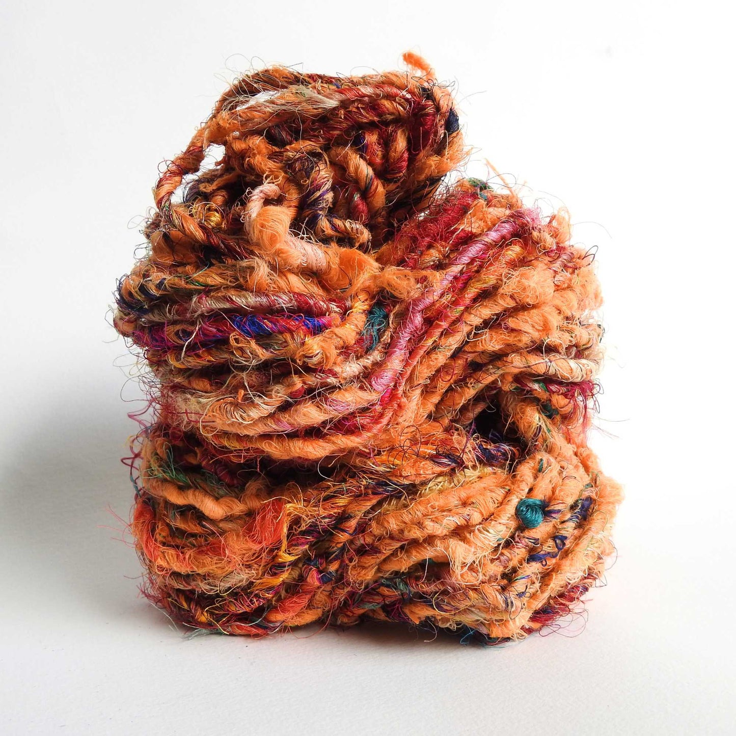 
                  
                    Ball of Recycled wool and silk yarn in orange. Soft, thick yarn for weaving, knitting, crochet and macrame. Hand spun, chunky natural yarn.
                  
                