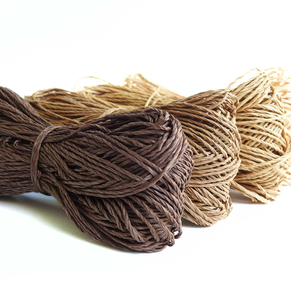Skeins of Sasawashi Bamboo Paper yarn in #9 Brown. Daruma Bamboo yarn for summer hats, bags, baskets. Eco friendly, vegan yarn for weaving, knitting, crochet, craft. Daruma Ito Yokota Sasawashi.