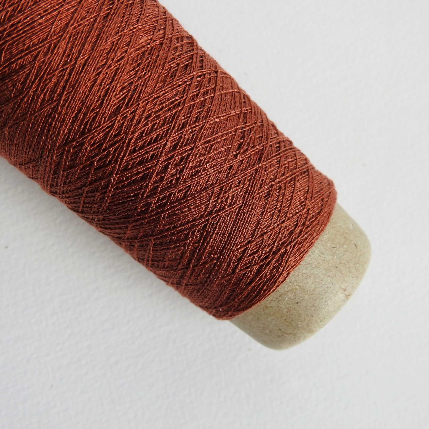 
                  
                    A cone of Silk Stainless Steel lace weight yarn in Brick for knitting crochet and weaving. Make beautiful scarves, garments and jewelry. The yarn has a stainless steel core with fine silk wrapped around it. They cone of yarn has a very elegant sheen and is beautiful to look at. Habu Textiles A20
                  
                