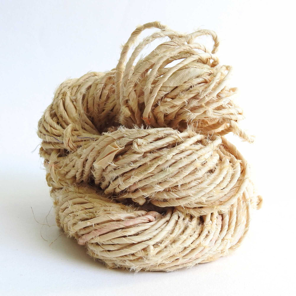 skein of upcycled sari cord in wheat. a matt silk cord, hand twisted and ideal for crafting hats, bags etc. 