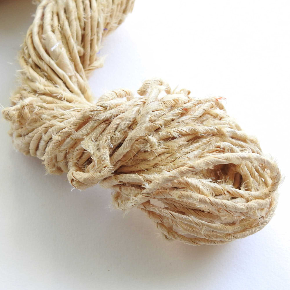
                      
                        skein of upcycled sari cord in wheat. a matt silk cord, hand twisted and ideal for crafting hats, bags etc. 
                      
                    