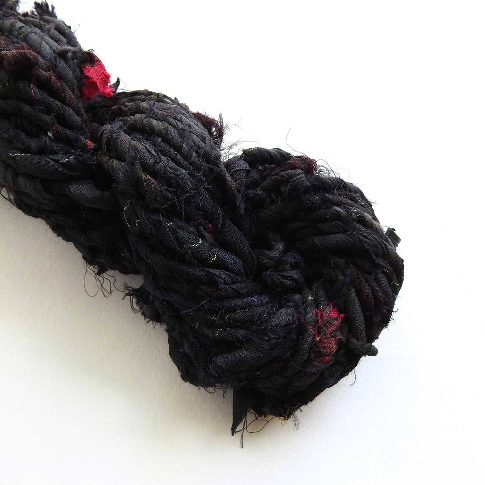 
                  
                    upcycled sari silk cord in black. strong, rustic matt silk cord for weaving, bags, hats etc.
                  
                