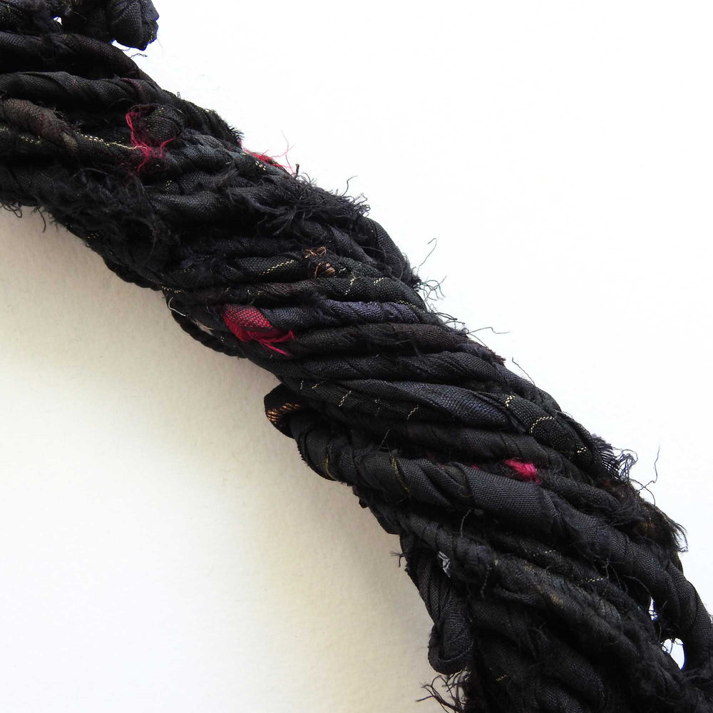 
                  
                    upcycled sari silk cord in black. strong, rustic matt silk cord for weaving, bags, hats etc.
                  
                