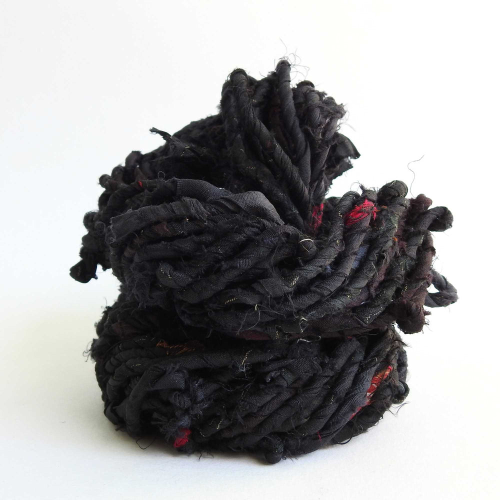 
                  
                    upcycled sari silk cord in black. strong, rustic matt silk cord for weaving, bags, hats etc.
                  
                