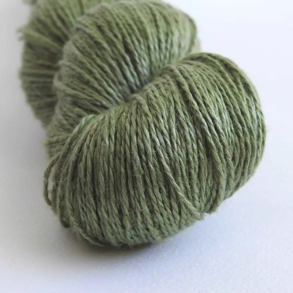 
                  
                    skein of linen yarn in martini olive. Linen yarn for knitting, weaving, crochet. Natural vegan yarn for summer, baby, socks.
                  
                