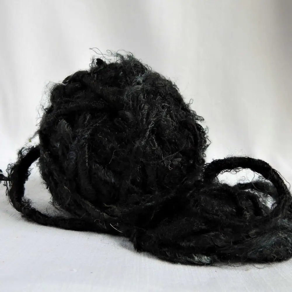 
                  
                    A ball of Banana Silk Yarn in Night. Natural, vegan banana fiber yarn for weaving, punch needle, knitting, crochet. Soft, squishy, chunky yarn.
                  
                