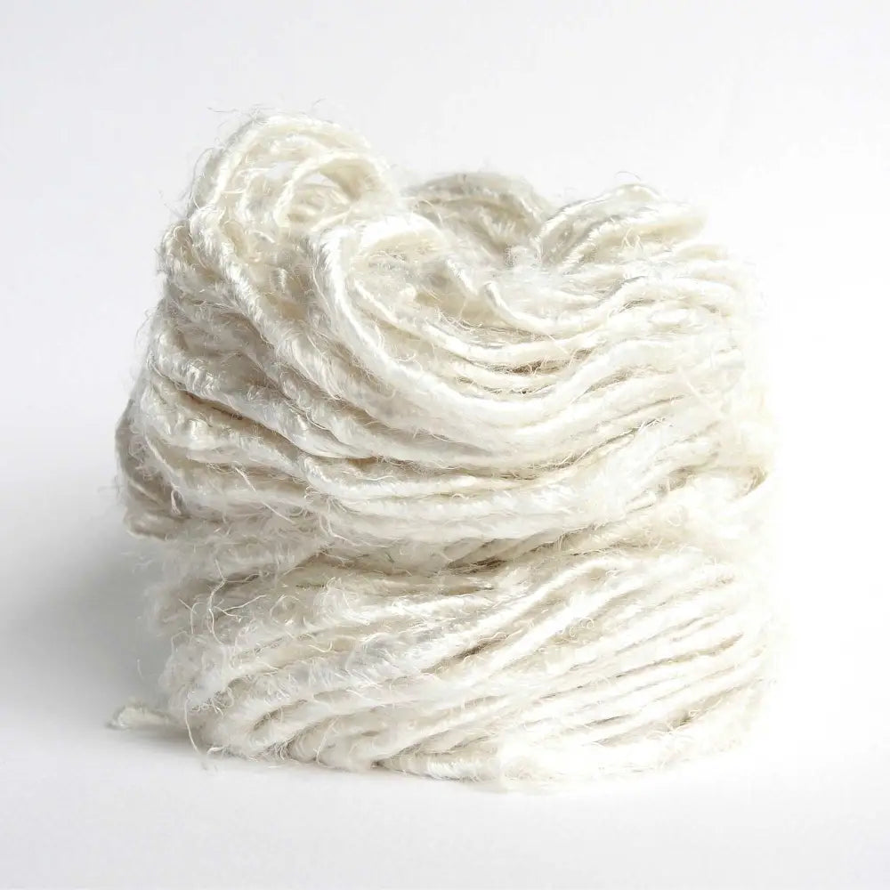 
                  
                    A ball of Banana Silk Yarn in Ivory. Natural, vegan banana fiber yarn for weaving, punch needle, knitting, crochet. Soft, squishy, chunky yarn.
                  
                