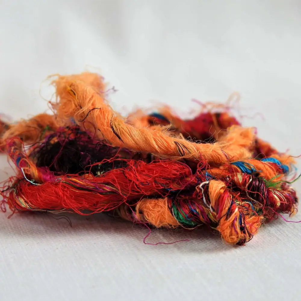 
                  
                    Ball of Recycled wool and silk yarn in orange closeup. Soft, thick yarn for weaving, knitting, crochet and macrame. Hand spun, chunky natural yarn.
                  
                