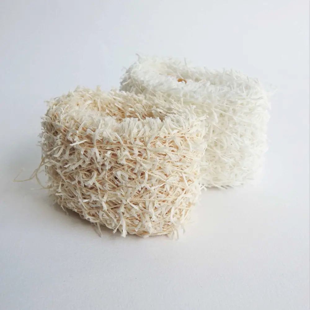Balls of Habu Textiles Cotton Cork Chenille Yarn in Natural and White. Soft, fluffy, cotton yarn for baby, scarves, garments, toys. Knitting, crochet, weaving yarn. Natural cotton vegan yarn. Habu yarn A-25