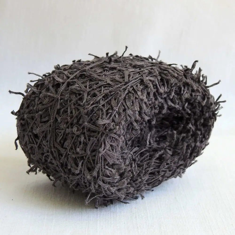 
                  
                    A Ball of Habu Textiles Cotton Cork Chenille Yarn in Charcoal. Soft, fluffy, cotton yarn for baby, scarves, garments, toys. Knitting, crochet, weaving yarn. Natural cotton vegan yarn. Habu yarn A-25
                  
                