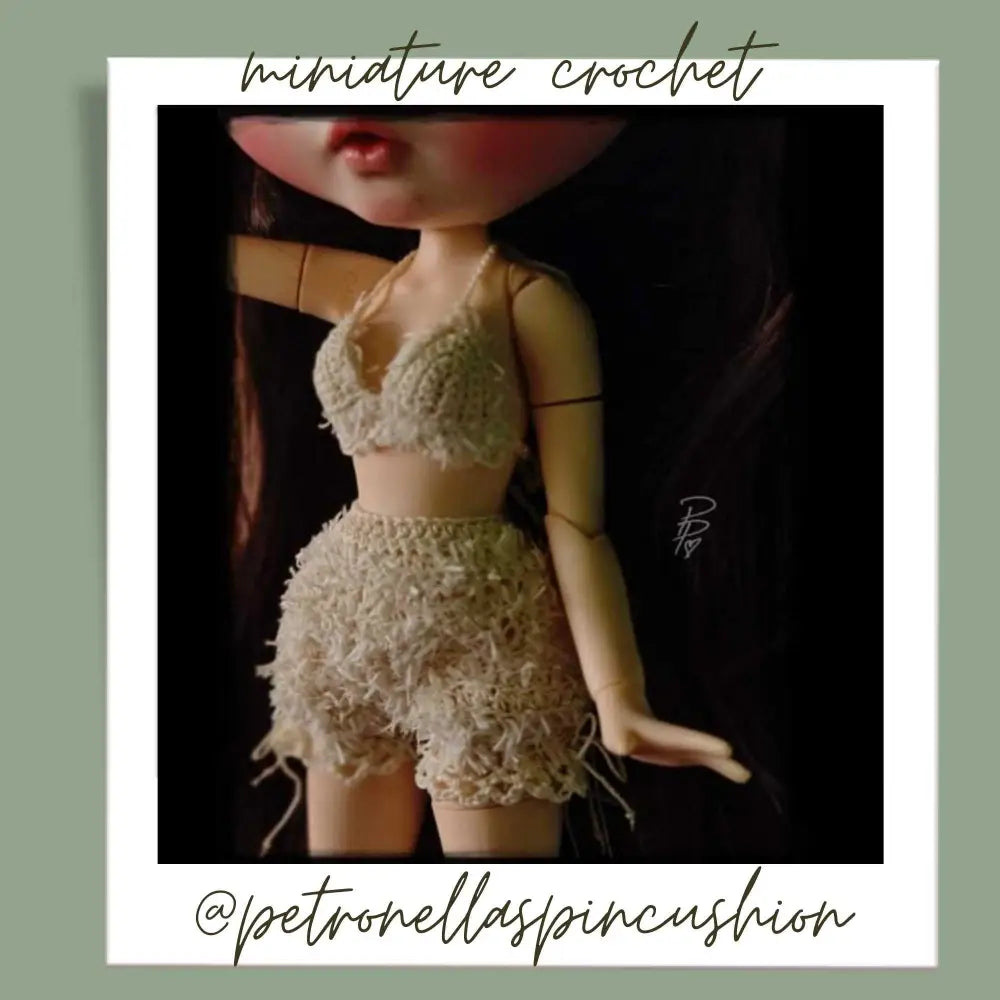 
                  
                    Miniature crochet set of shorts and bra on doll. Crocheted by @petronellaspincushion using Habu Textiles Cotton Linen Paper Moire in Beige
                  
                