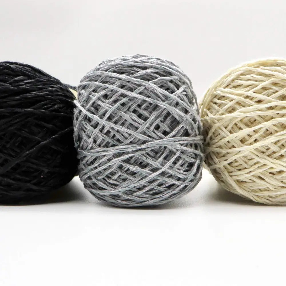 
                  
                    Balls of Habu Linen Cotton Paper Yarn  in Black, Gray and Off White. Use for weaving, knitting and crochet. Create garments, hats, bags, baby clothes. Natural vegan yarn. Use for warp yarn when weaving. Habu yarn A-188
                  
                