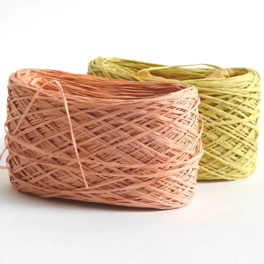 
                  
                    ball of habu textiles raw silk wrapped paper yarn in peach and yellow green.. Japanese paper yarn for weaving, crochet, knitting. Habu Textiles Raw Silk Wrapped Paper Yarn N-24b
                  
                