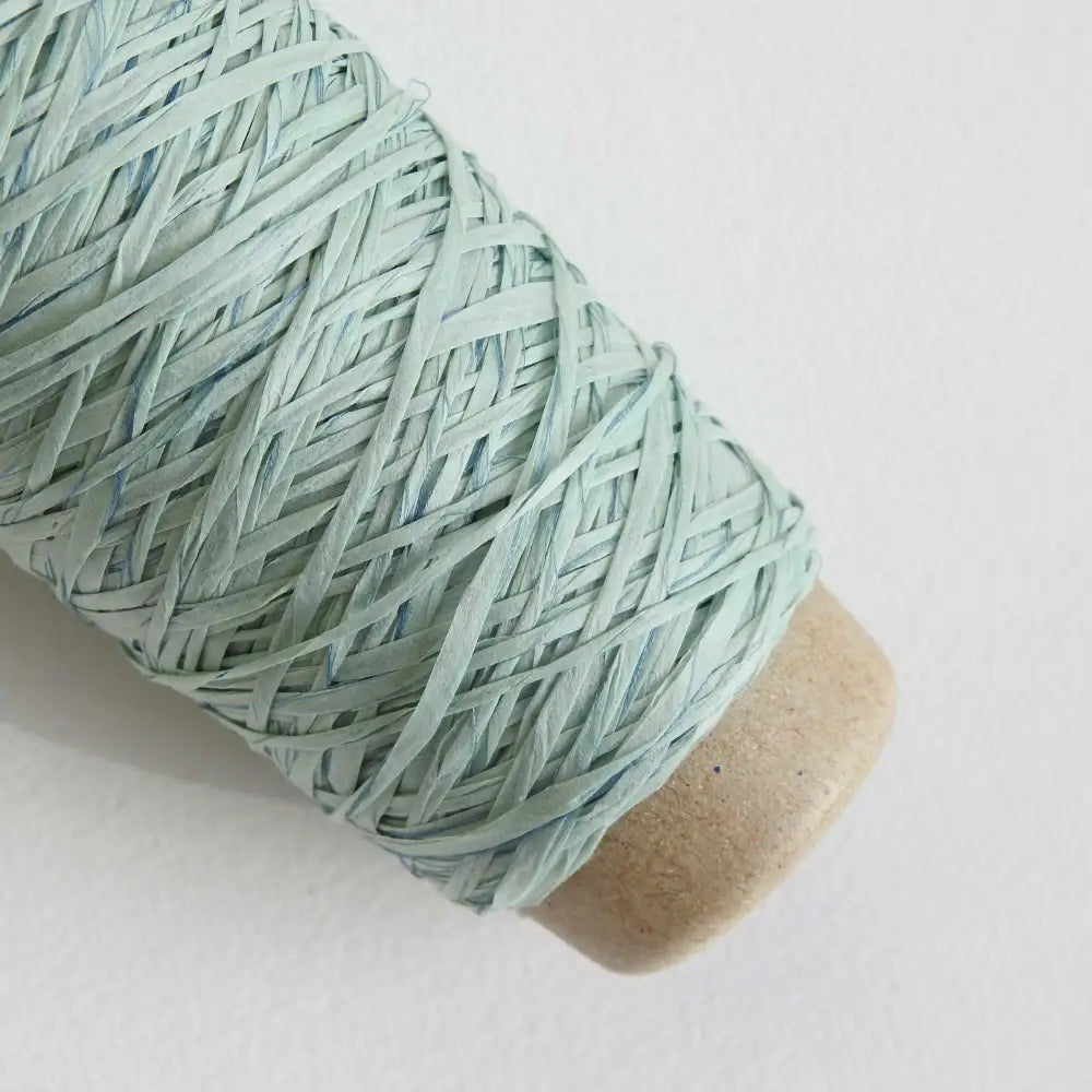 
                  
                    ball of habu textiles raw silk wrapped paper yarn in sky blue. Japanese paper yarn for weaving, crochet, knitting. Habu Textiles Raw Silk Wrapped Paper Yarn N-24b
                  
                