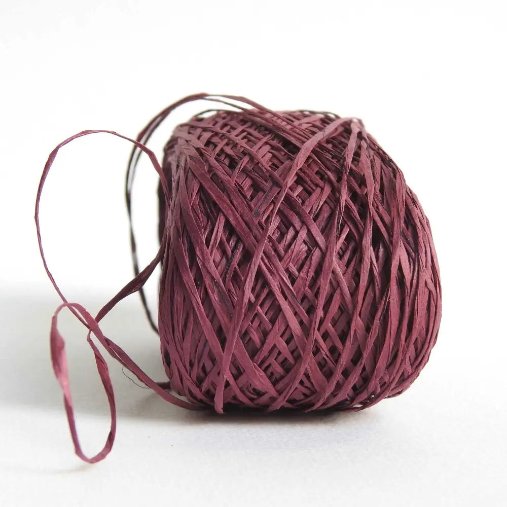 
                  
                    ball of habu textiles raw silk wrapped paper yarn in wine. Japanese paper yarn for weaving, crochet, knitting. Habu Textiles Raw Silk Wrapped Paper Yarn N-24b
                  
                