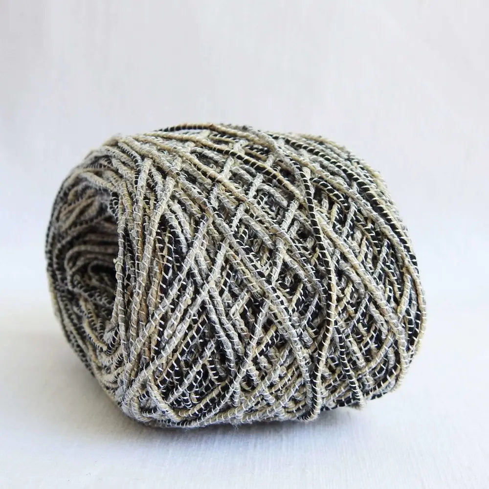 
                  
                    Ball of Habu Textiles Tsumugi Silk Combination in Sesami. Japanese silk cord crafted using traditional technique. Silk threads wrapped with silk to create a thick silk cord. Habu Textiles Tsumugi Silk Combination A111. Habu yarn australia
                  
                