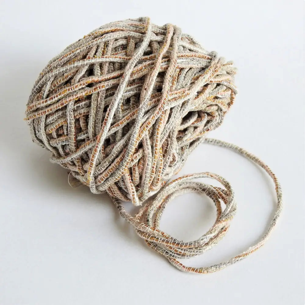 
                  
                    Ball of Habu Wrapped Tsumugi Silk combination in Sand. Soft silk cord made using traditional Japanese techniques. Habu Textiles Silk Wrapped Tsumugi A110
                  
                