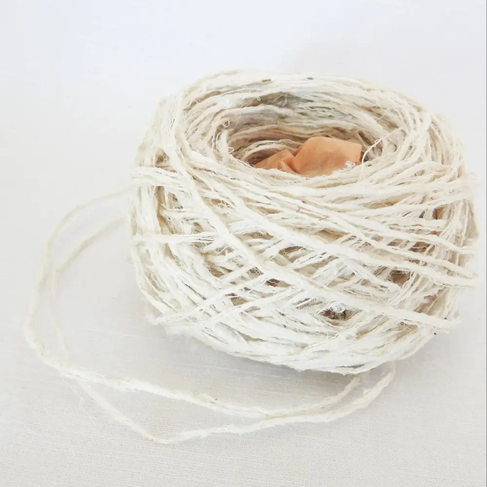 
                  
                    A ball of Habu Textiles Kibiso Silk yarn. 100% raw silk slow crafted chunky yarn for weaving, textile arts. Ball of natural silk yarn. Make beautiful bags, sculptural garments and textile art. Habu Textiles N-63
                  
                