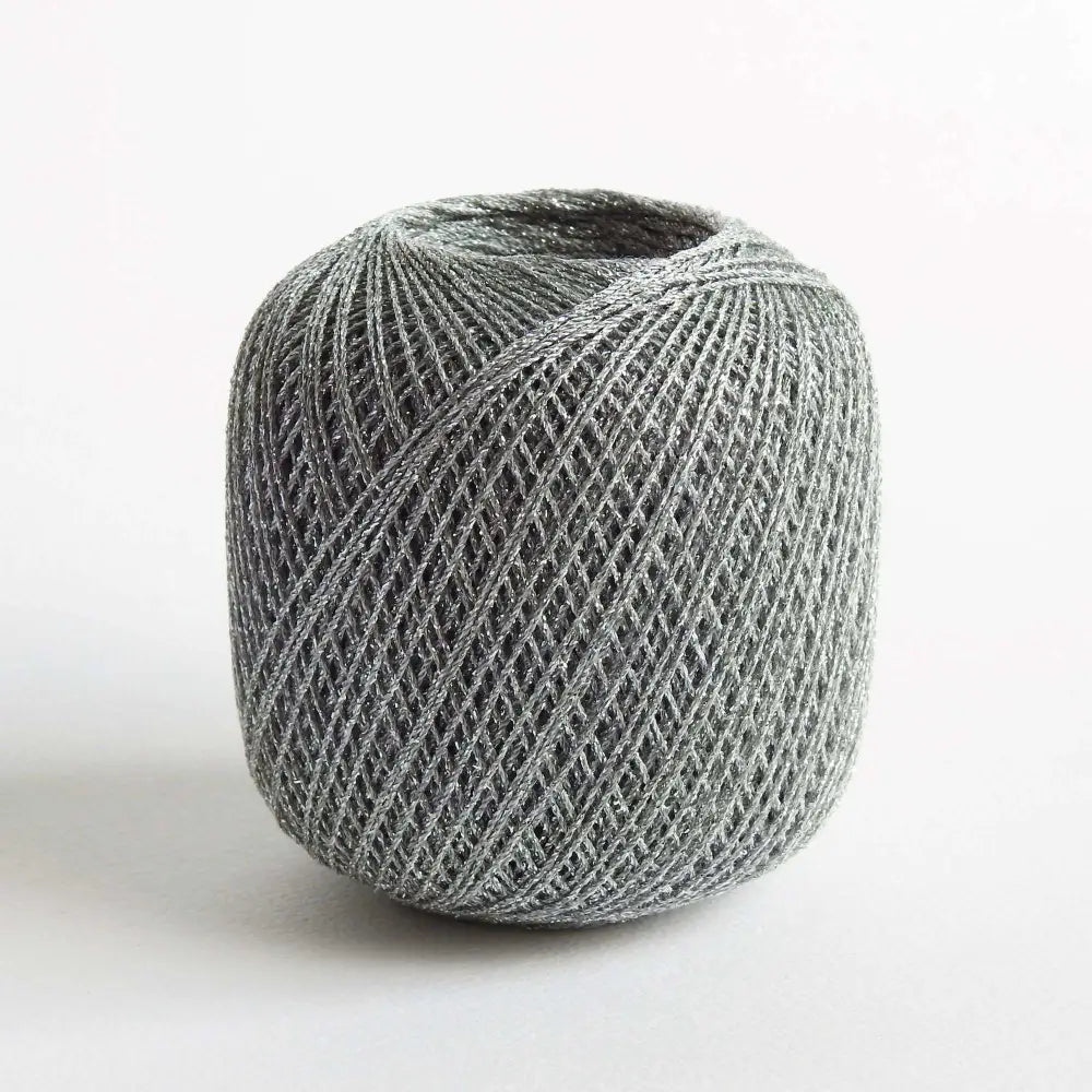 
                  
                    Ball of metallic yarn in silver. Glitter yarn, soft and shiny yarn with beautiful drape. Lurex metallic yarn for crochet, knitting, tatting, weaving, tassels and embroidery. Daruma Lurex Lame Leaf thread
                  
                