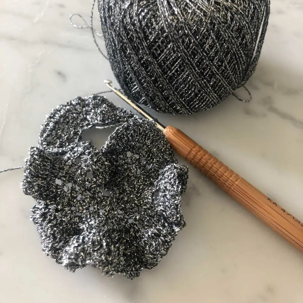 
                  
                    Fishnet mesh sock crocheted using Metallic glitter yarn in black. Glitter yarn, soft and shiny yarn with beautiful drape. Lurex metallic yarn for crochet, knitting, tatting, weaving, tassels and embroidery. Daruma Lurex Lame Leaf thread
                  
                