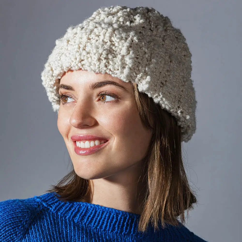 
                  
                    A womens hat knitted using Pascuali Nube yarn. A chunky wool yarn. Baby soft boucle yarn for scarf, jumper, blanket, baby, hat. A Mulesing-free wool grown and harvested sustainably.
                  
                