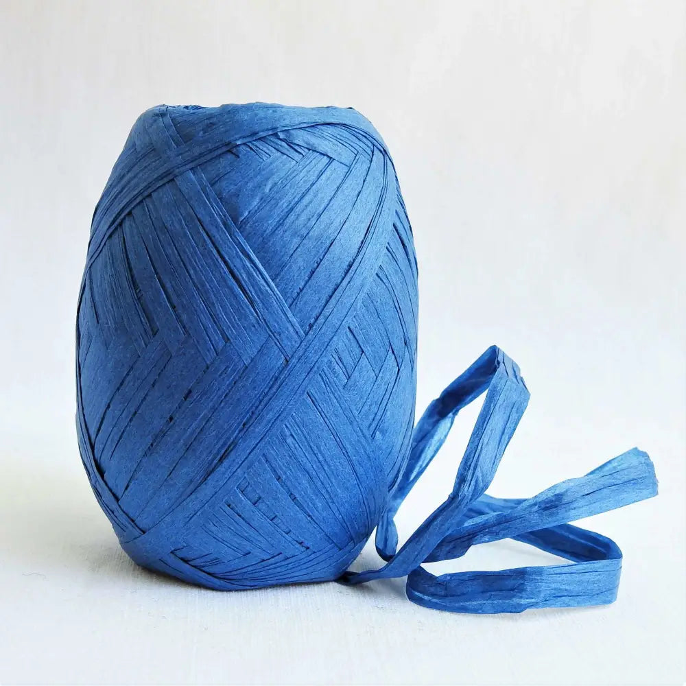 
                  
                    Ball of Raffia yarn for weaving, crochet and crafting in Blue. Natural soft raffia for baskets, hats, bags and mats. Vegan, eco friendly coloured raffia ribbon.
                  
                