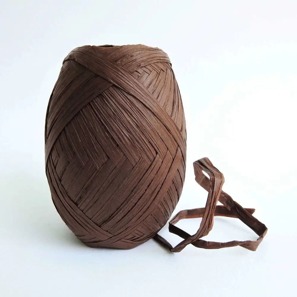 
                  
                    Ball of Raffia yarn for weaving, crochet and crafting in Dark Brown. Natural soft raffia for baskets, hats, bags and mats. Vegan, eco friendly coloured raffia ribbon.
                  
                