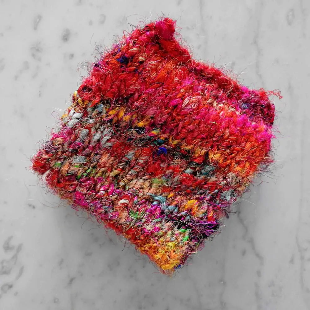 
                  
                    Scarf knitted in Recycled Sari Silk yarn in colour Fiesta.  Chunky yarn for knitting, weaving, crochet, craft. Recycled, sustainable, natural yarn. 
                  
                